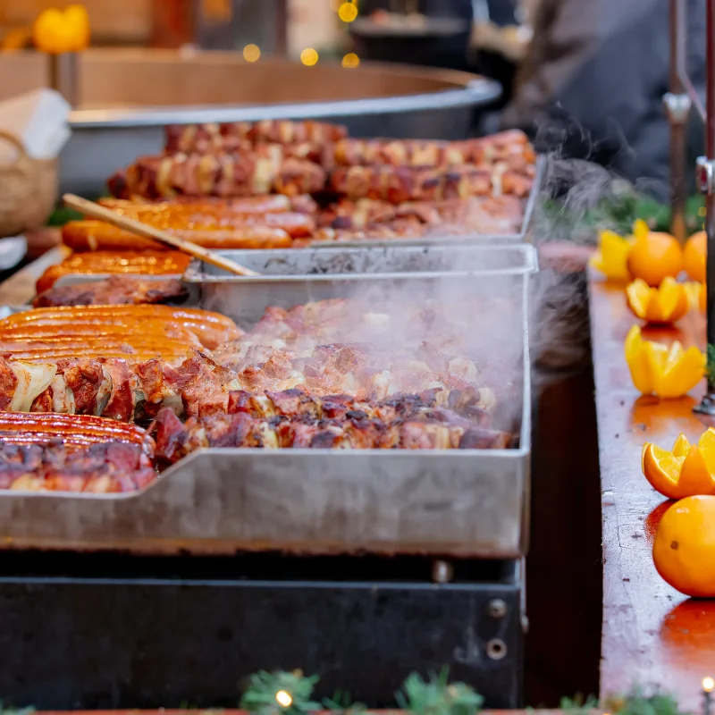 photo of meat being cooked on a flat BBQ.