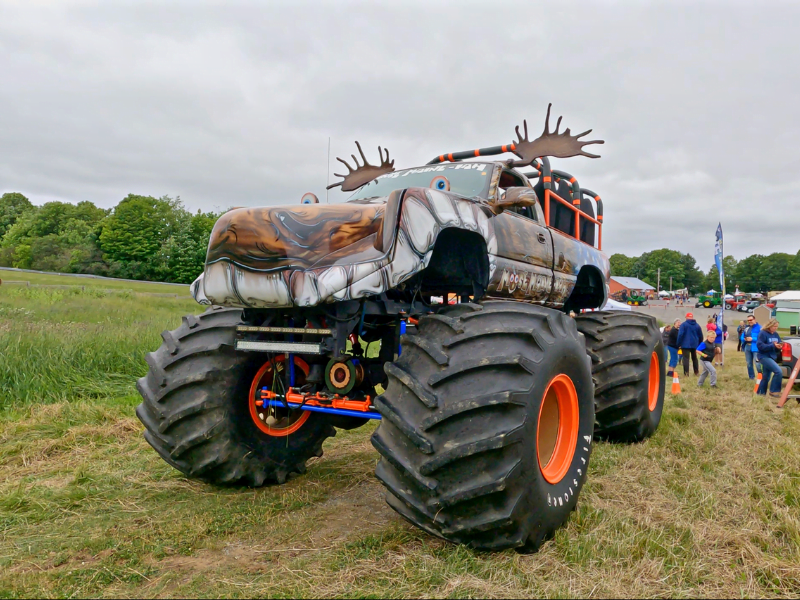 Monster truck with fake moose antlers on the top.