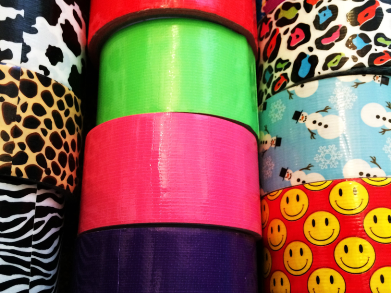 Rolls of colorful duct tape stacked on one another.
